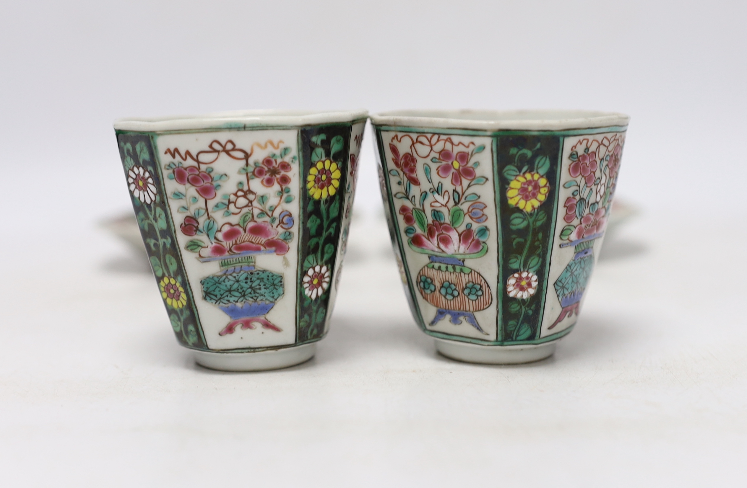 A pair of Chinese Qianlong famille rose octagonal cups and saucers, with panelled floral decoration, saucers 12cm cups height 6.5cm diameter 6.75cm